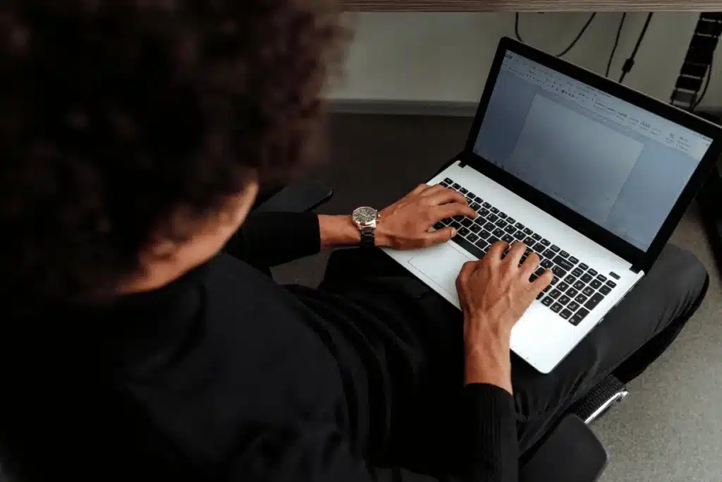 Overhead view of man working on Word document.