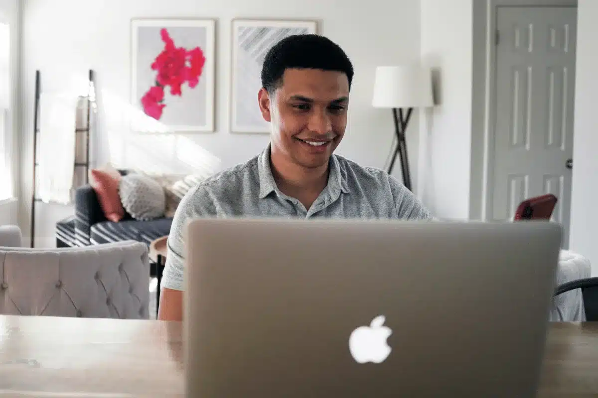 Man working on a MacBook at home.