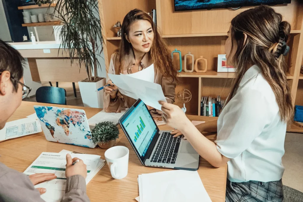 Colleagues discussing project details during a meeting.