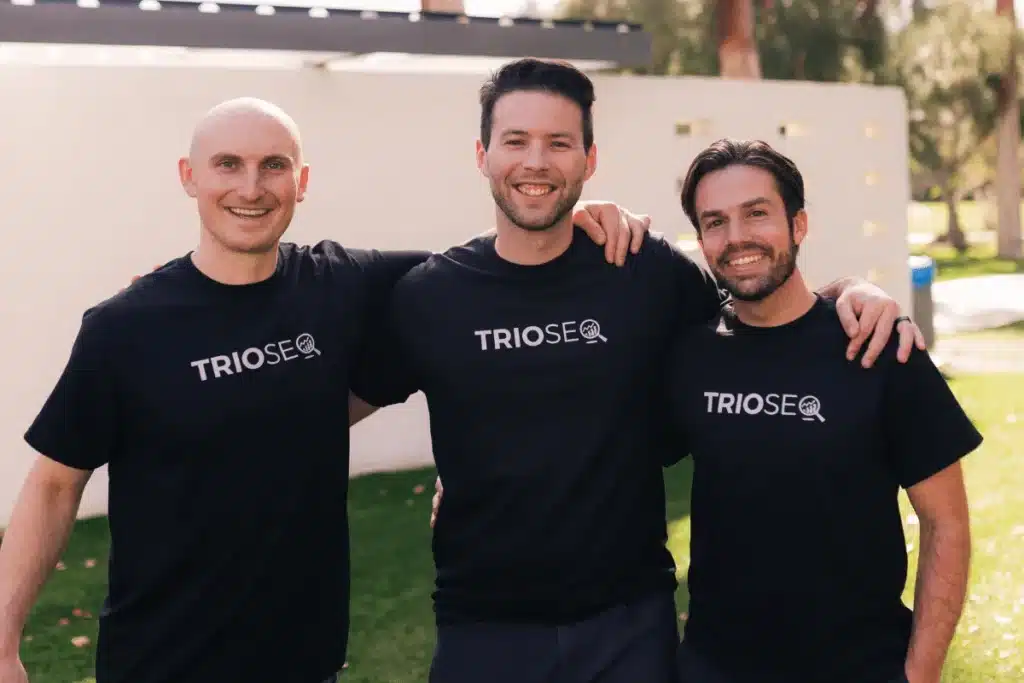 Nathan stands left, Steven in center, Connor right, all in TRIOS&reg; t-shirts outdoors.